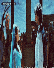 a man and a woman are looking at each other in a scene from a movie ..