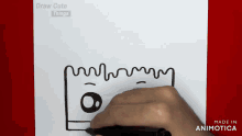a person is drawing a cartoon character with a marker on a piece of paper