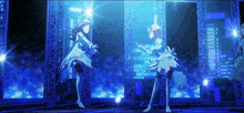 two anime girls are dancing on a stage with a blue background