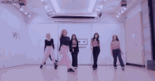 a group of girls are dancing in a room that says secret