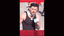 a man wearing a black tank top with the number 23 on it