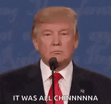 donald trump is giving a speech in front of a microphone and saying `` it was all chinnnna '' .
