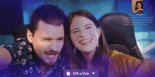 a man and a woman are posing for a selfie with a gift a sub button in the corner