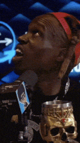 a man talking into a microphone with the words welcome what is written below him