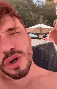 a man with a beard is making a funny face with his mouth open
