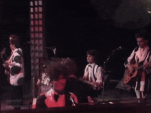 a group of people playing instruments on a stage with a sign that says zos