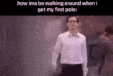 a man in a white shirt is walking around a pole .