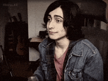 a young man wearing a plaid shirt and a denim jacket with the name mary_t3 on the bottom right