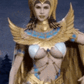 a woman in a gold and blue costume is standing in front of a dark background .