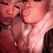 two women are making funny faces with their mouths open .