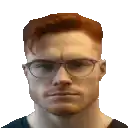 a man with red hair and glasses is wearing a black shirt and looking at the camera .