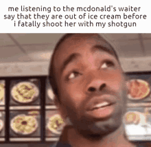 a man is listening to the mcdonald 's waiter say that they are out of ice cream before i fatally shoot her