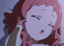 a cartoon girl with pink hair and a cat 's paw on her face