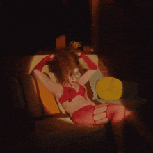 a woman laying on a couch with a clown makeup on her face