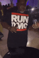 a man wearing a shirt that says run dmc is dancing