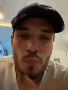 a close up of a man wearing a hat