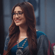 a woman wearing glasses and a necklace with the hashtag shivangivids on the bottom