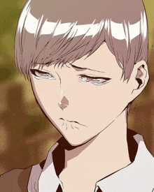 a close up of a person 's face with a sad look on their face