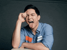 a man sticking his tongue out and wearing a shirt with msgm written on it