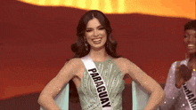 a woman is wearing a sash that says paraguay on it .