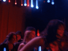 a blurry picture of a woman dancing with her arms in the air