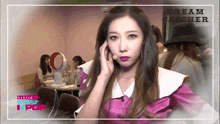 behind the scenes of a kpop show with a woman in a pink dress