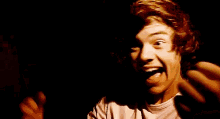 a young man with red hair is making a funny face