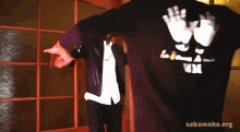 a man wearing a black shirt that says lp on it is standing next to another man