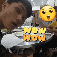 a group of people are sitting around a table with the words wow wow written on it