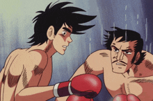 a man with boxing gloves is standing next to another man