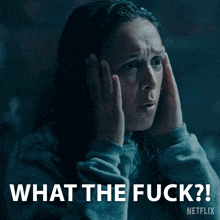 a woman covering her ears with her hands and the words " what the fuck " written above her