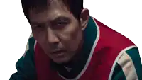 a man wearing a red green and white striped shirt