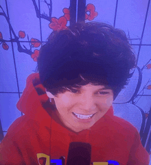 a young boy wearing a red hoodie with the letter d on the front