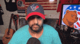 a man wearing a texans hat is sitting at a desk