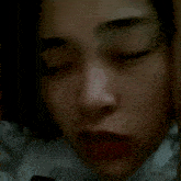 a close up of a woman 's face with foreign writing on the bottom