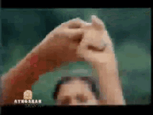 a blurry picture of a person 's hands with ayngarab video written in the corner