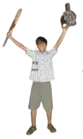 a boy wearing a shirt that says p32 joy holds up a bat