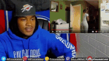 a man wearing a blue hoodie that says princeton is watching a video