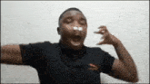 a man with a bandage on his nose is making a funny face with his arms outstretched .