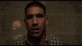 a man in a mask is holding a gun in a room