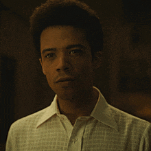 a man wearing a white shirt with a button down collar
