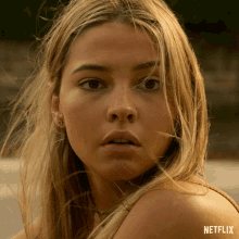 a close up of a woman 's face with the word netflix on the bottom right