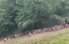 a blurred image of a group of people running in a field .
