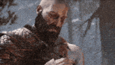 a man with a beard is holding a small animal in his hand