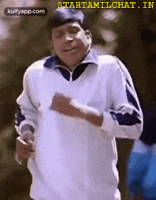 a man in a white shirt is running with a cigarette in his hand