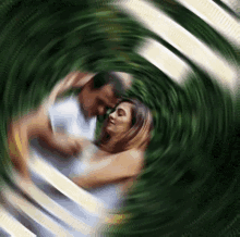 a blurry picture of a man and woman hugging in a circle