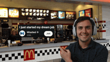 a man wearing headphones stands in front of a mcdonalds counter