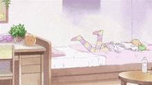 a girl is laying on her back on a bed in a bedroom .