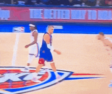 two basketball players on a court with a sign that says the jets