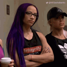 a woman with purple hair is wearing a black shirt that says integrity .
